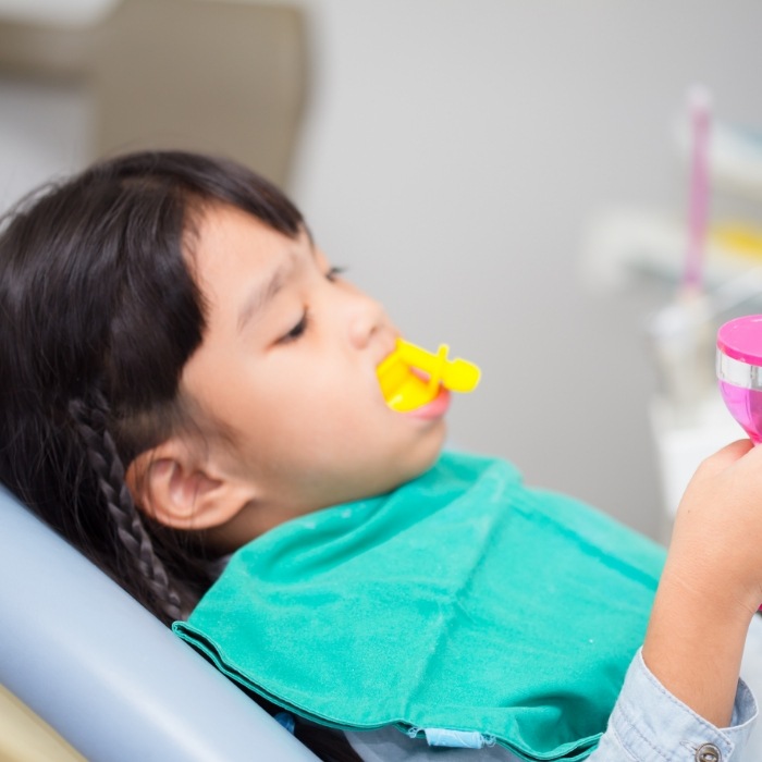 Child getting silver diamine fluoride in dental office