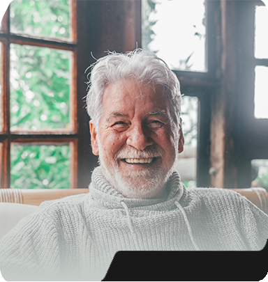 Smiling senior man in gray sweater