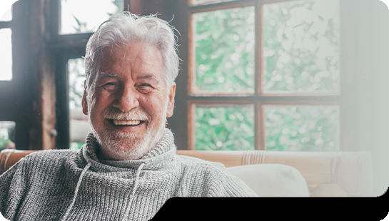 Smiling senior man in gray sweater