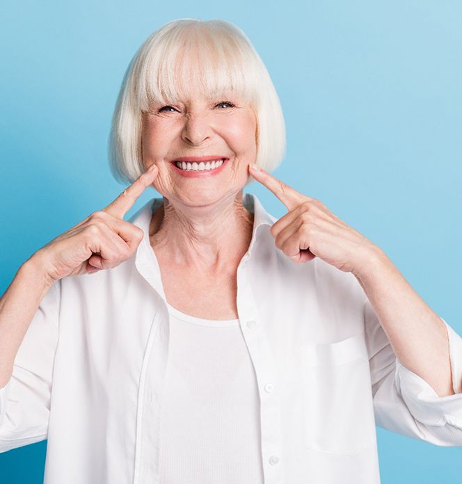 Senior woman pointing to her smile