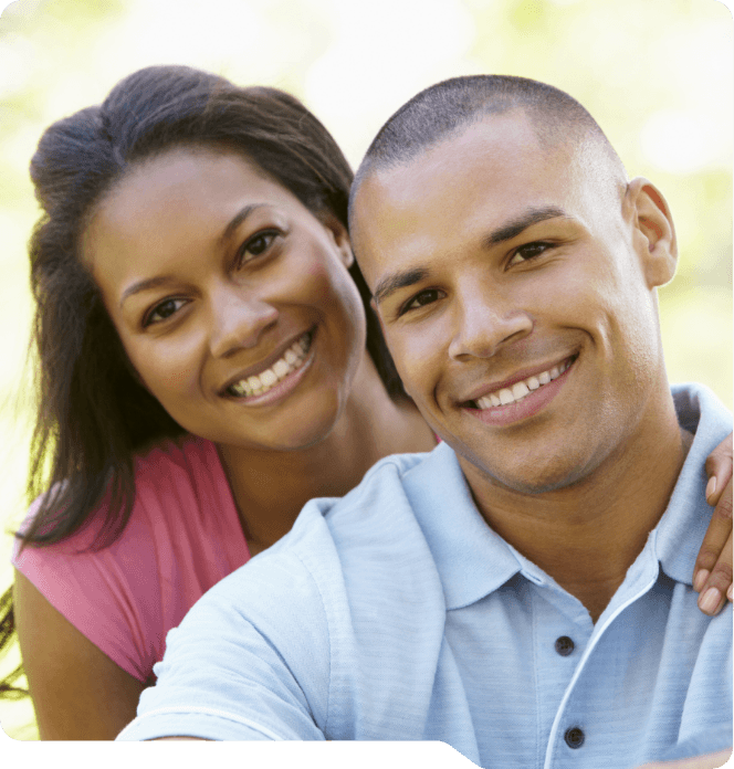 Man and woman smiling outdoors after visiting The Grand Prairie Dentist