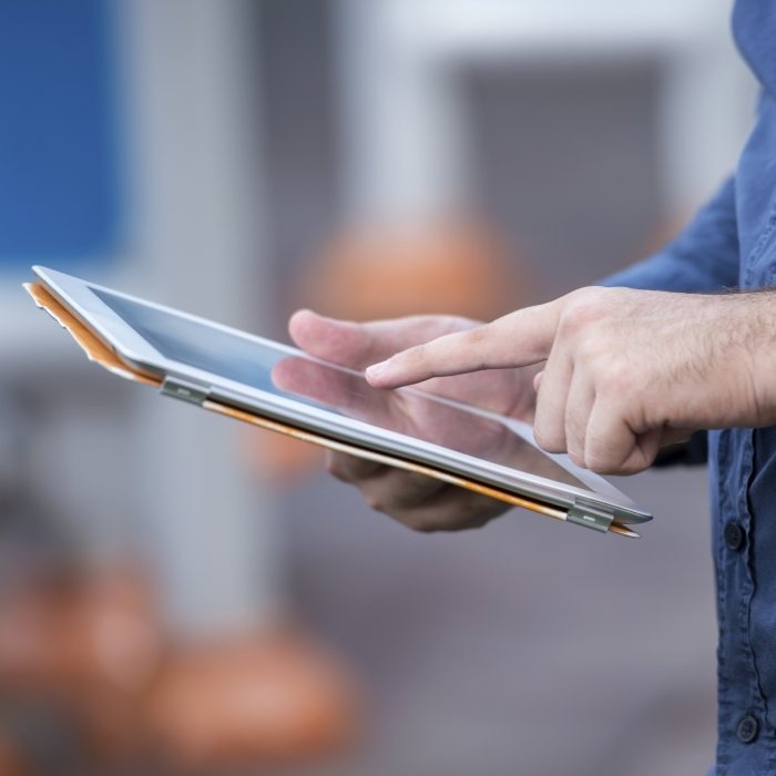 Person typing on tablet