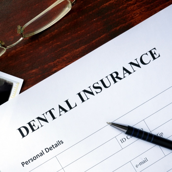 Dental insurance form on dark wood table