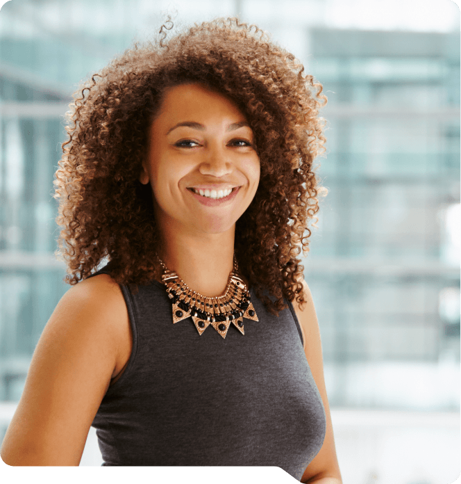 Woman smiling in front of window after gum disease treatment in Grand Prairie