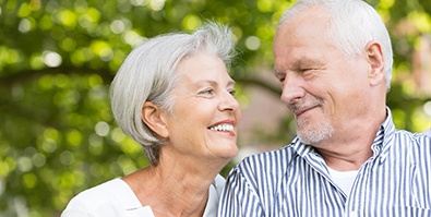 older couple smiling while looking at each other