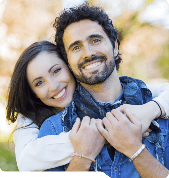 Man and woman smiling outdoors after dental services in Grand Prairie