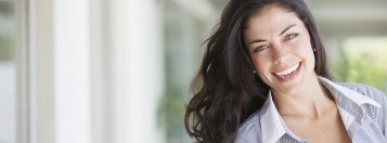 WOman in white collared shirt smiling