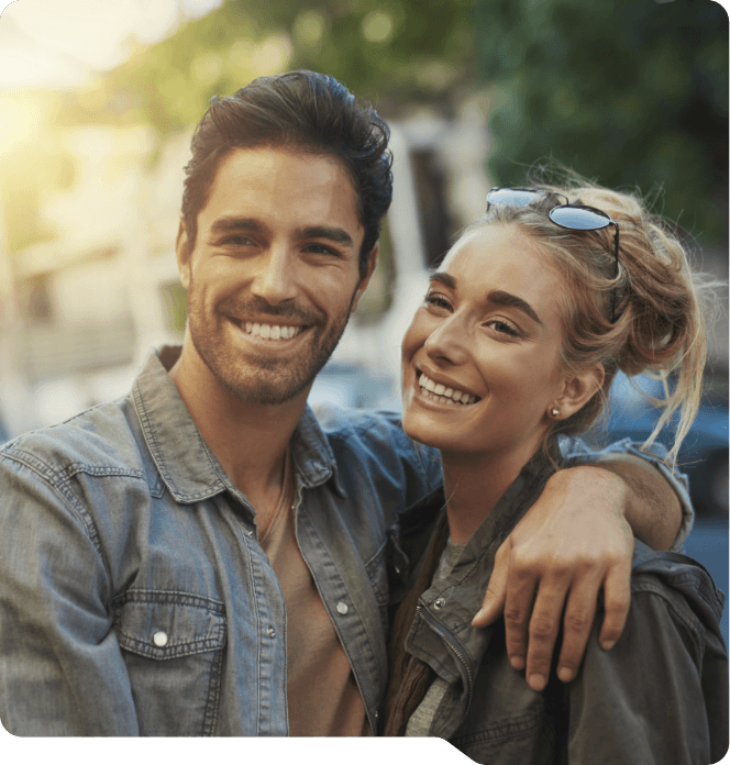 Man and woman smiling outdoors after preventive dentistry in Grand Prairie