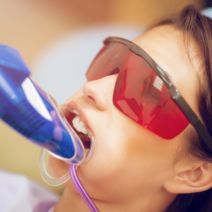 Young girl getting fluoride treatment during preventive dentistry visit