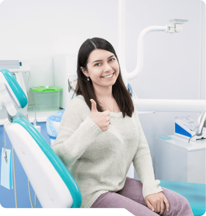 Woman giving thumbs up in dental chair after using dental special offers in Grand Prairie