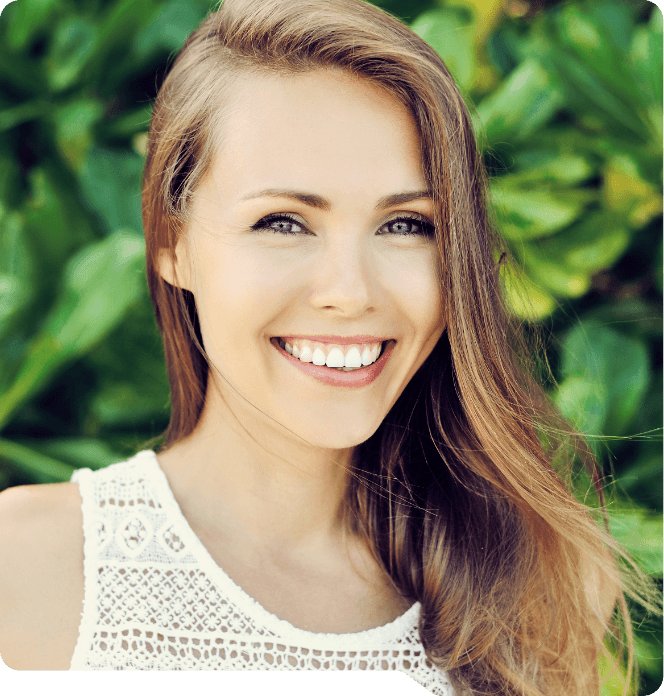 Young woman smiling outdoors after wisdom tooth extractions in Grand Prairie